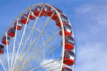 red ferris wheel with blue sky