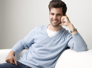 Young man sitting on sofa