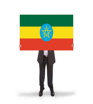 Businessman holding a big card, flag of Ethiopia
