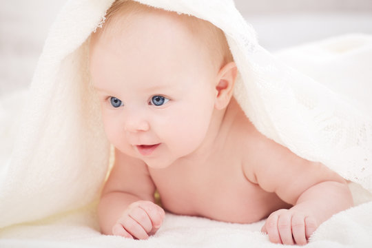 baby under a white blanket
