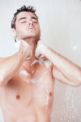 young handsome man in shower