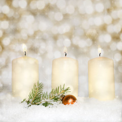 Brightly lit candles in snow