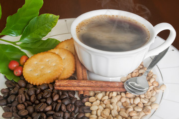 Smoking hot coffee,  beans,Cinnamon and Cracker .