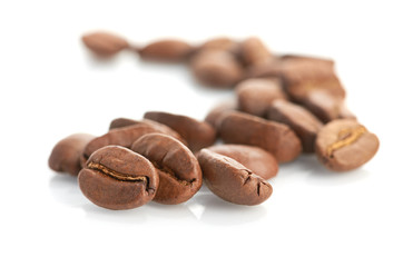 Macro of coffee beans isolated on white background