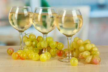 White wine in glass on room background
