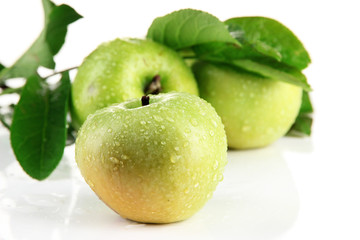 Juicy green apples with leaves, isolated on white
