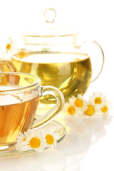 Cup of herbal tea with camomiles close up