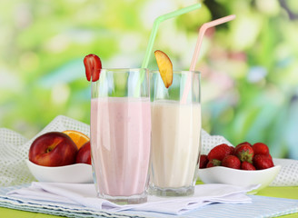Delicious milk shakes with strawberries and peach