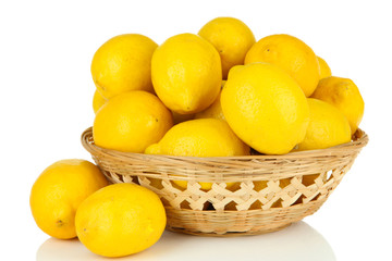 Ripe lemons in wicker basket isolated on white