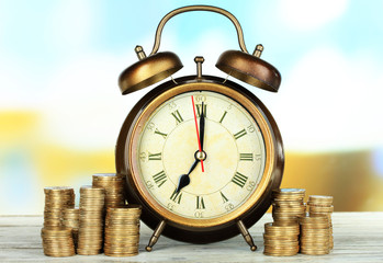 Alarm clock on table on bright background