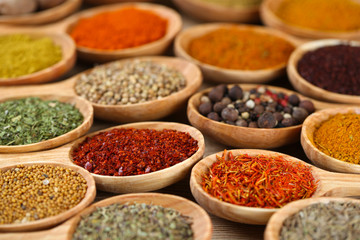 Assortment of spices in wooden spoons close-up