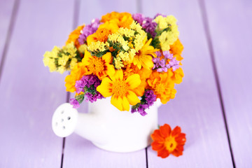 Bouquet of marigold flowers in watering can