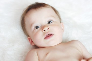 lovely baby on white plaid
