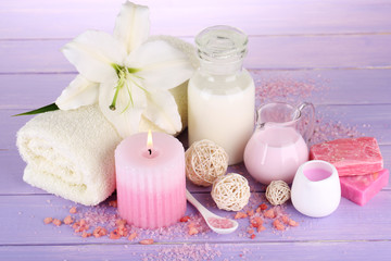 Beautiful spa setting with lily on wooden table close-up