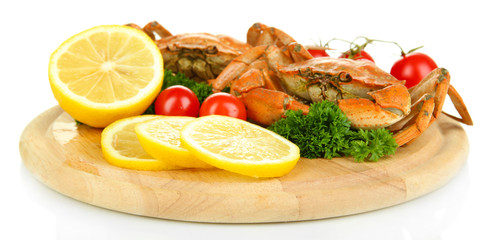 Boiled crabs with lemon slices and tomatoes,