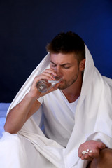 Handsome young man in bed