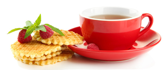 Cup of tea with cookies and raspberries isolated on white