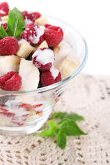 Fruit salad in glass bowl, isolated on white