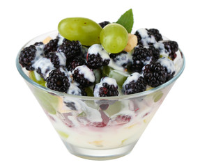 Fruit salad in glass bowl, isolated on white