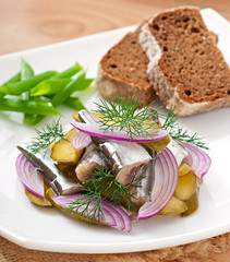 herring salad with pickled cucumbers and onions