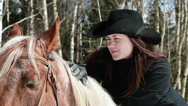 girl cowboy sitting on a horse closeup