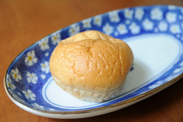 A bun bread in dish on the table.