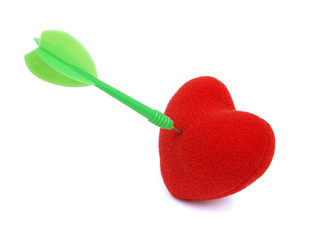 Red heart stabbed by green dart on white background