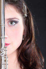 girl and flute on a black background © anetlanda