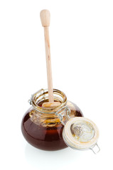 Jar of honey with wooden drizzler