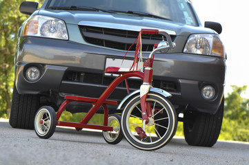 Child's Tricycle in front of SUV