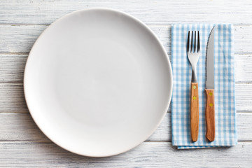 white plate with fork and knife