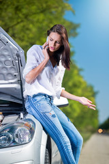 Beautiful woman with car trouble talking over a phone