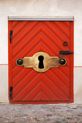Small Red wooden door with large keyhole