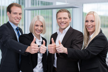 lachende geschäftsleute zeigen daumen hoch