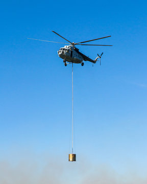 Helicopter in action carrying the water bucket.