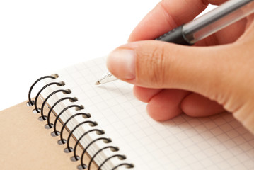 Notebook and hand with pen
