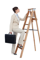Businesswoman climbing career ladder with briefcase