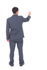 Businessman standing back to camera writing with marker