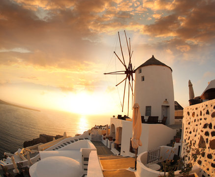 Fototapeta Windmill in Santorini against sunset, Greece