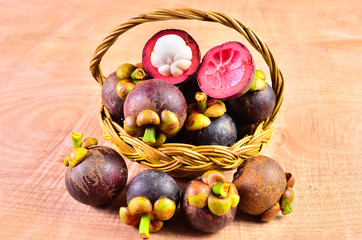 Fresh fruit in a basket on a wooden floor