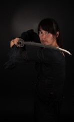 Asian woman holding her sword