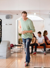 Young Man Bowling in Club