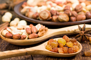 nuts and raisins in wooden spoons