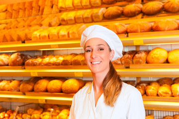 Female baker selling bread in bakery