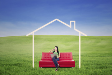 Thoughtful female in dream house outdoor