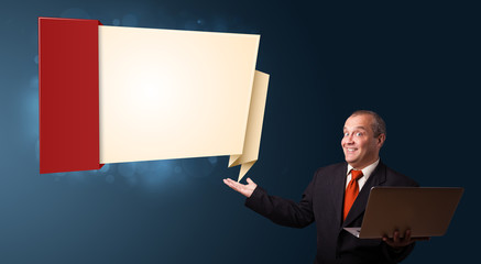 Businessman holding a laptop and presenting modern origami copy