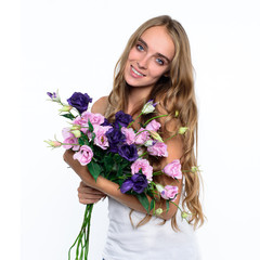 Beautiful happy woman holding bouquet of flowers
