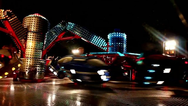 Carousels in amusement park at night