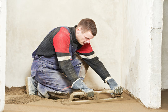 Plasterer concrete worker at floor work