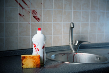 Bottle of dishwashing liquid with bloody fingerprints